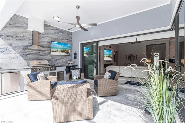 View of patio / terrace with grilling area, ceiling fan, exterior kitchen, and an outdoor hangout area