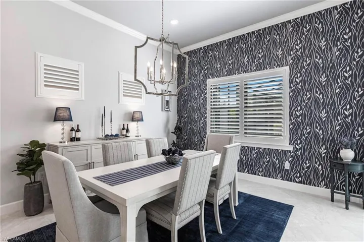 Dining space featuring an inviting chandelier and ornamental molding