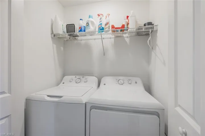 Laundry Closet complete with washer and dryer