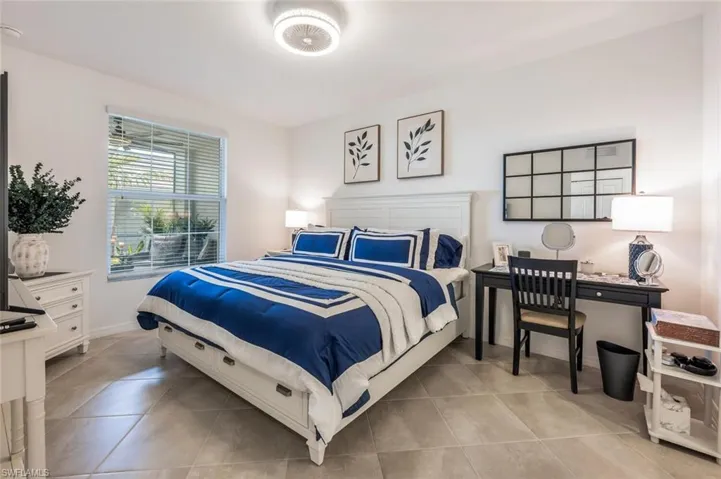 Bedroom with light tile patterned floors and baseboards