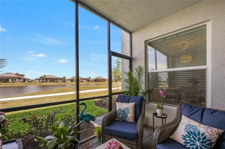 Sunroom featuring a water view