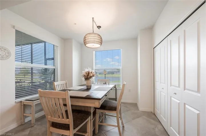 Dining area featuring light tile patterned floors and baseboards