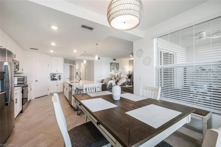 Dining space featuring a ceiling fan, light tile patterned flooring, recessed lighting, and visible vents