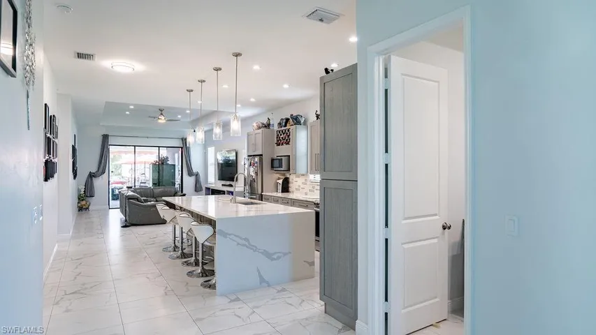 Open-concept interior featuring light marble-look tile flooring throughout