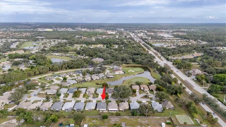 Aerial overview of property's location with a large body of water and nearby suburban area