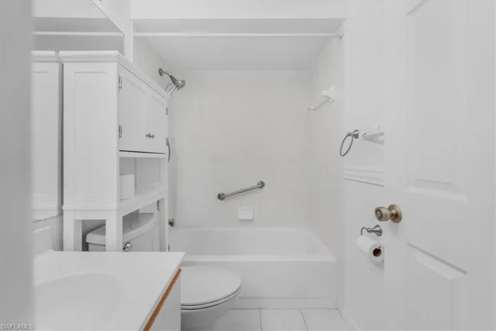 Bathroom with vanity and  shower combination