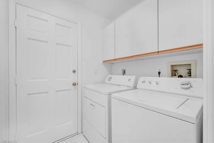 Laundry area featuring washer and dryer and cabinet space