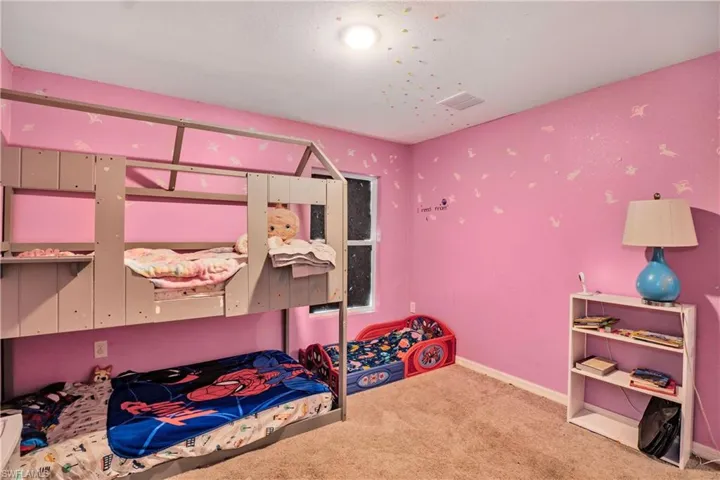 Bedroom featuring carpet floors and baseboards