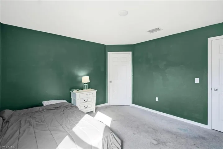 Carpeted bedroom with baseboards