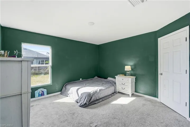 Carpeted bedroom with baseboards