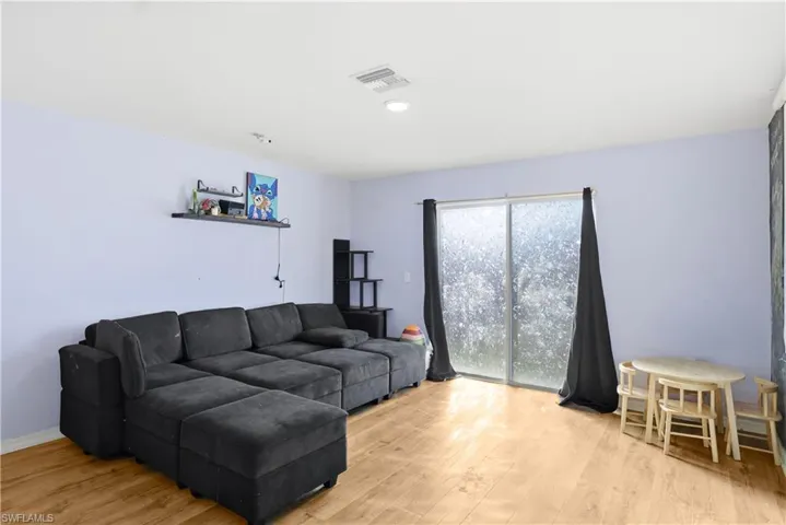 Living room with light wood-style floors and recessed lighting