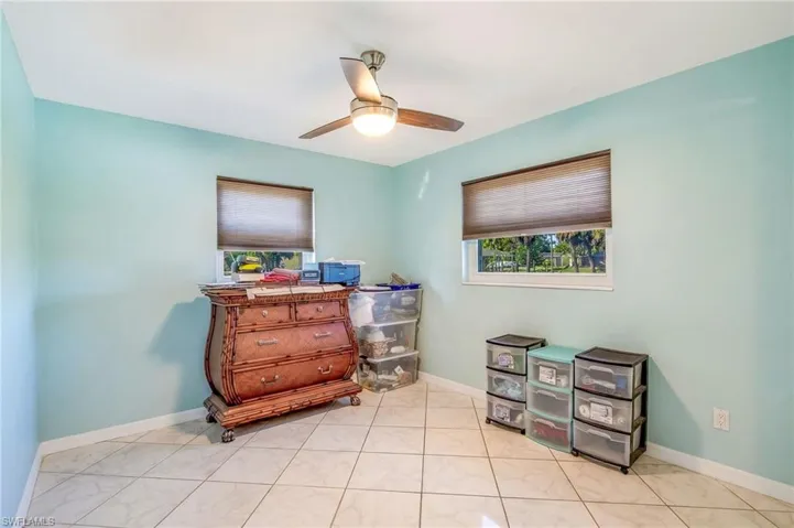 Bedroom with ceiling fan and baseboards