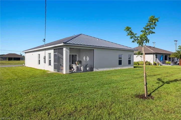 Back of property featuring a yard
