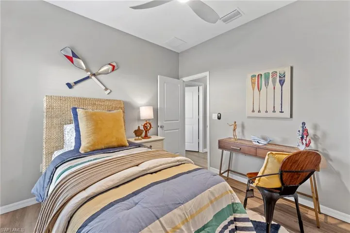 Bedroom with ceiling fan and hardwood / wood-style floors