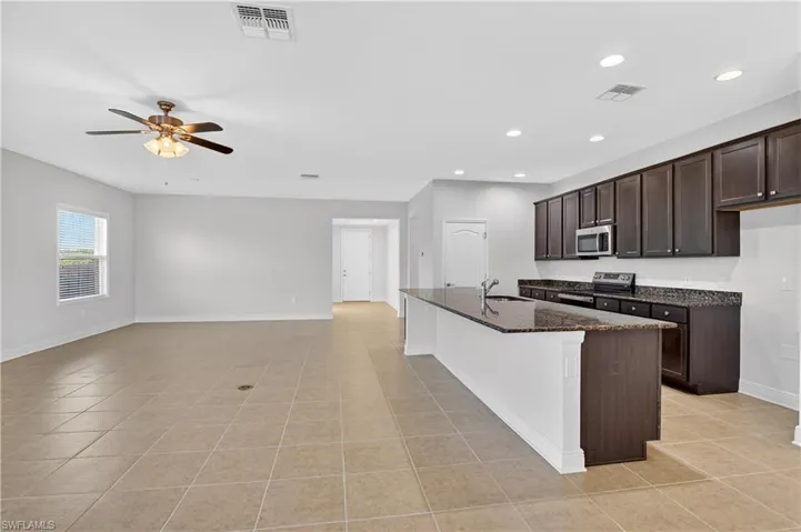 Another view of the kitchen relative to the living room and dining room
