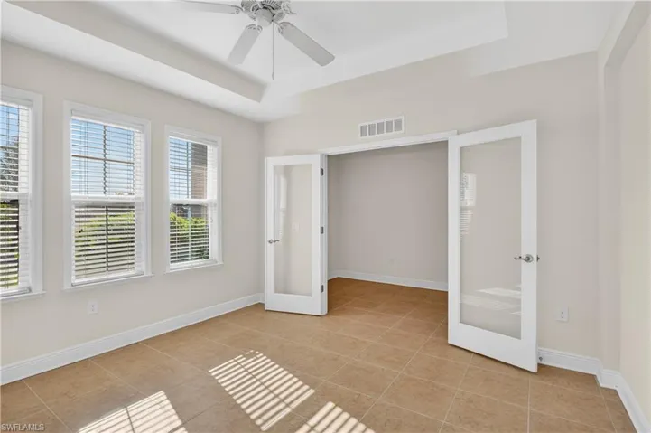 Den/Office has large windows for beautiful sun and glass doors for privacy.