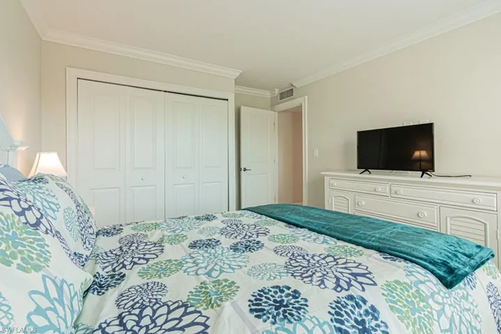 Bedroom featuring ornamental molding and a closet