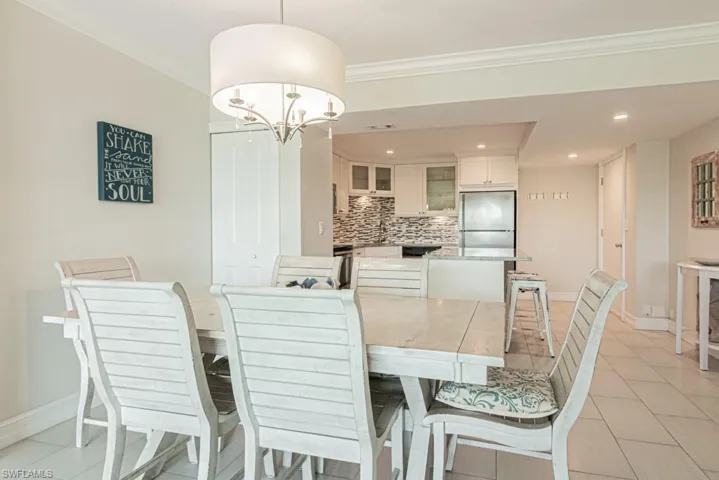 Dining space featuring baseboards, a chandelier, ornamental molding, and recessed lighting