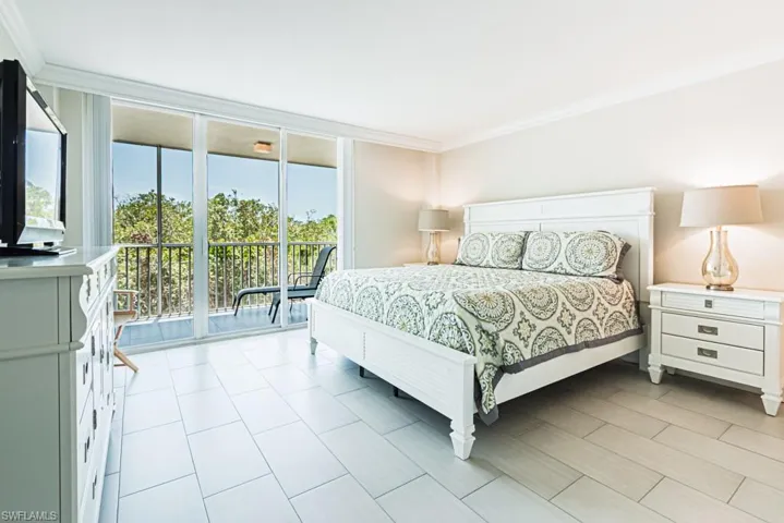 Bedroom with access to exterior and crown molding