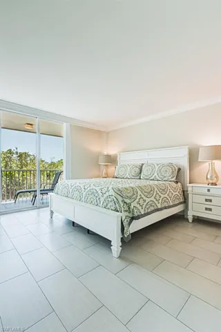 Bedroom with access to exterior and ornamental molding