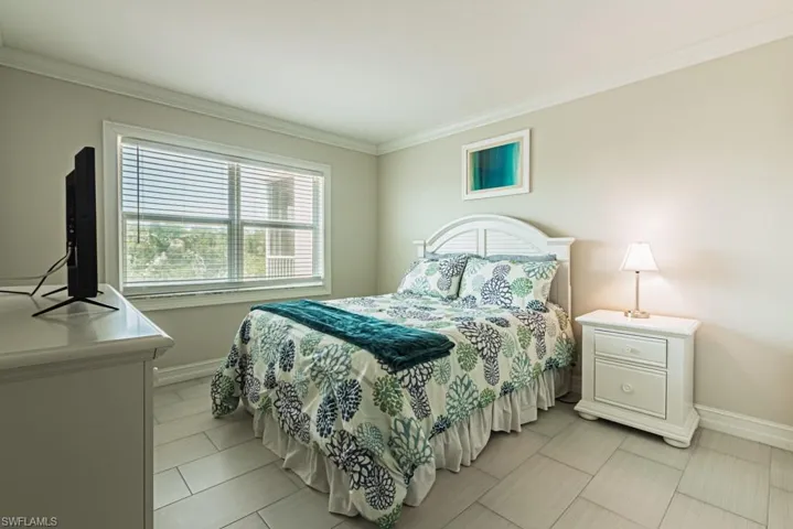Bedroom with baseboards and ornamental molding
