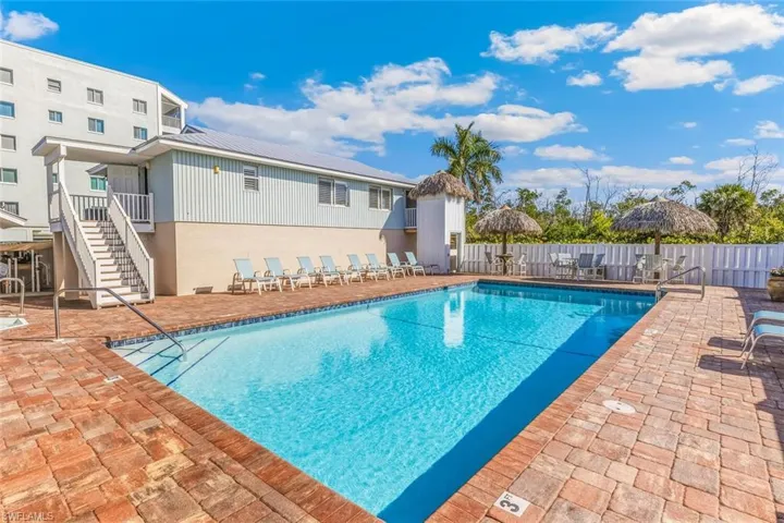 Community pool with a patio area and stairway
