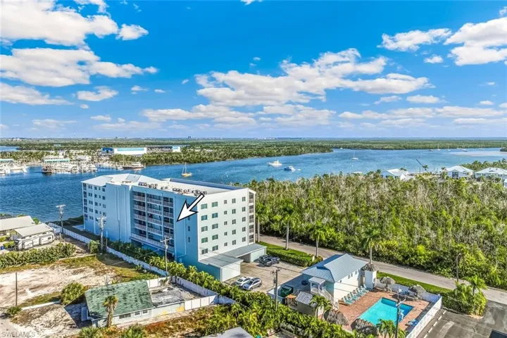 Bird's eye view of a nearby body of water and apartment complex / building