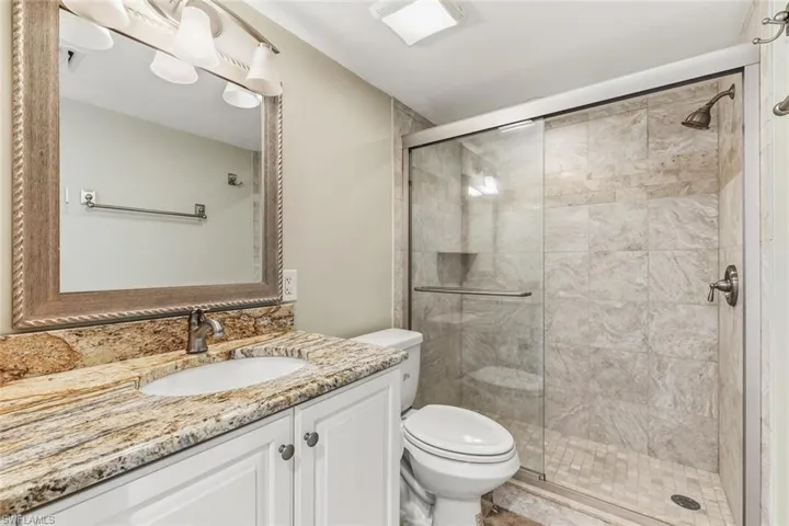 Full bath featuring vanity and a stall shower