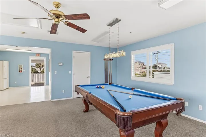 Game room with pool table, plenty of natural light, and a ceiling fan