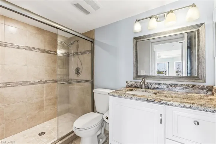 Bathroom with vanity and a shower stall