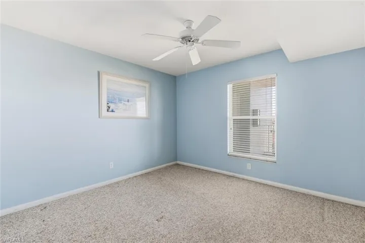 Empty room with carpet and ceiling fan