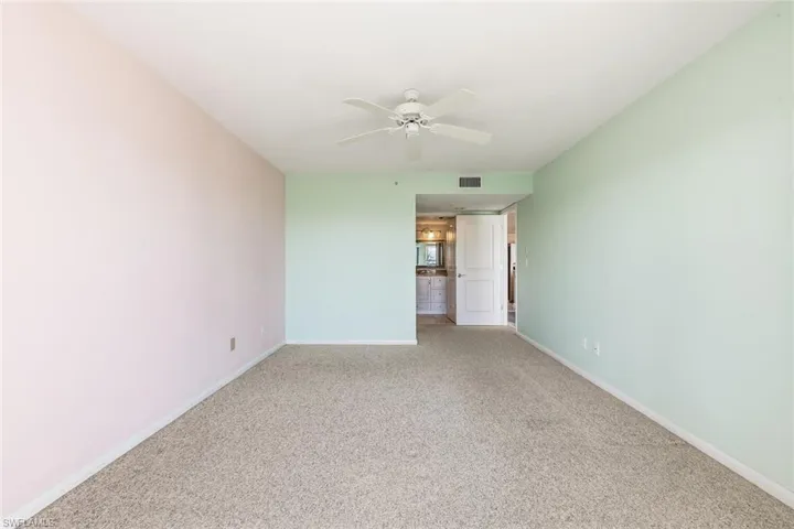 Unfurnished room with carpet floors and a ceiling fan