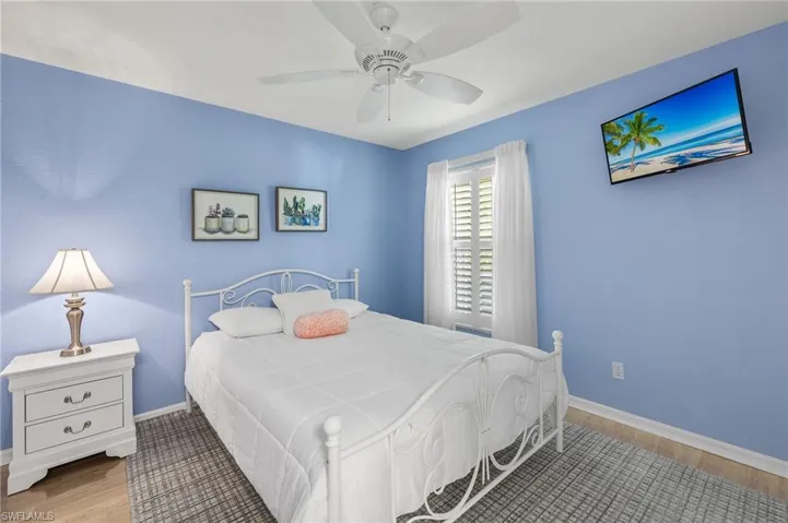 Bedroom with ceiling fan and light wood-type flooring