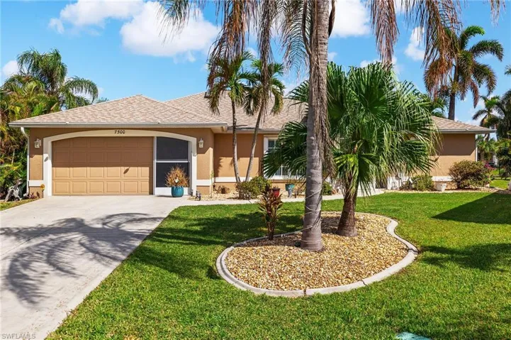 Ranch-style home featuring a front yard and a garage