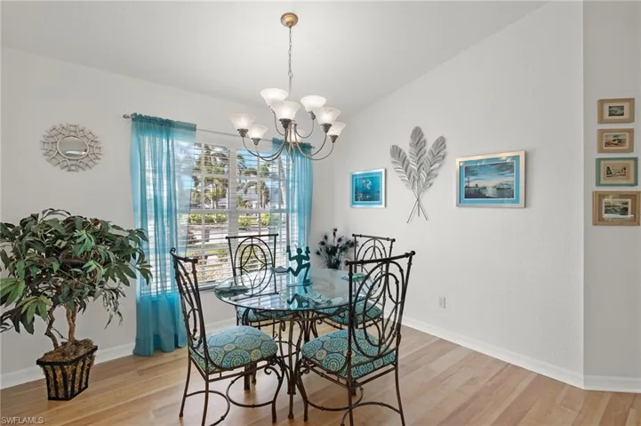 Dining space featuring light hardwood / wood-style floors and an inviting chandelier