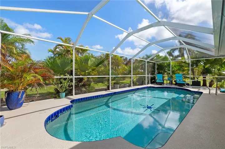 View of swimming pool featuring a patio and a lanai