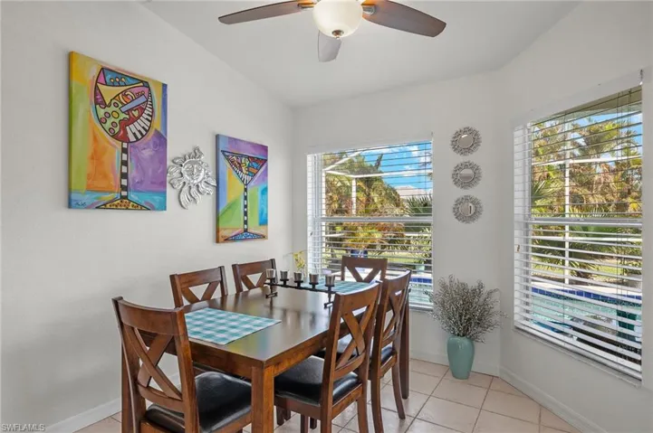 Tiled dining area featuring ceiling fan