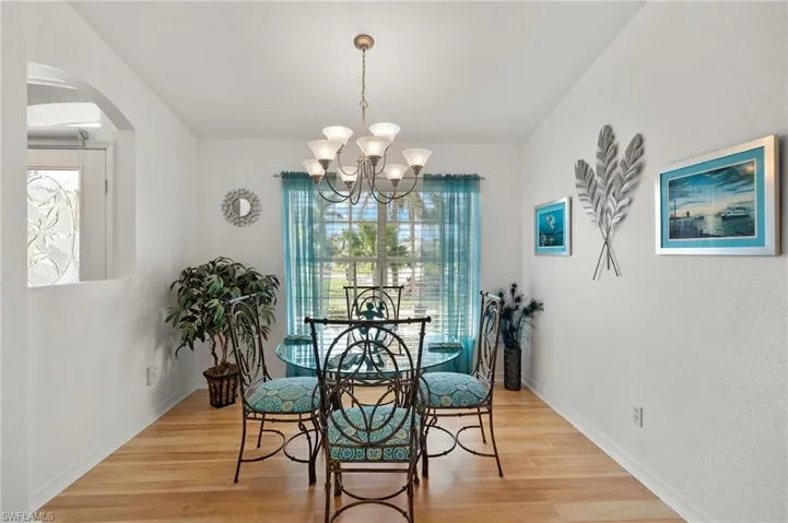 Dining area featuring a notable chandelier and light hardwood / wood-style floors