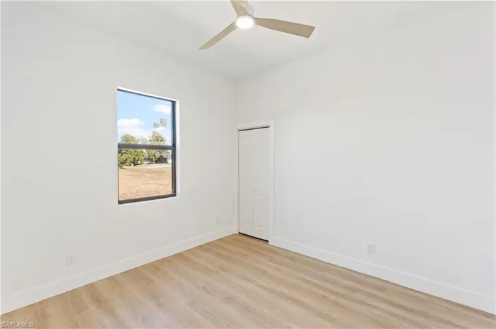 Spare room featuring light wood-style flooring and ceiling fan