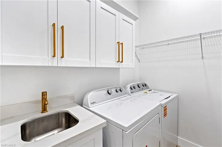 Laundry area featuring washing machine and dryer and cabinet space