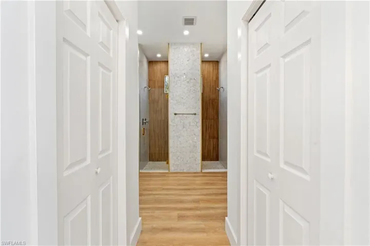Corridor featuring light wood-style flooring and recessed lighting