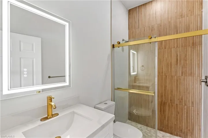 Bathroom with a stall shower and vanity