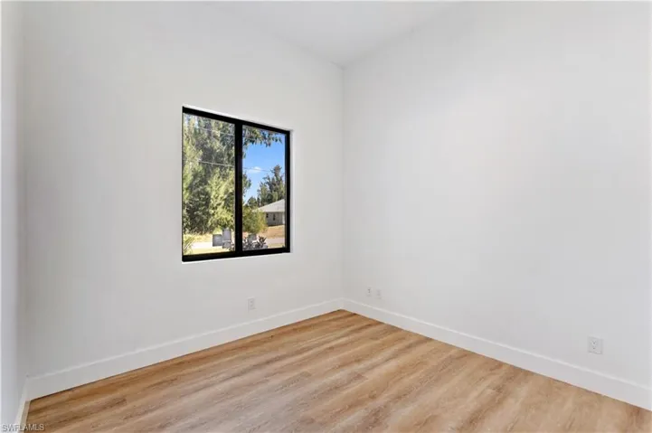 Empty room with baseboards and wood finished floors