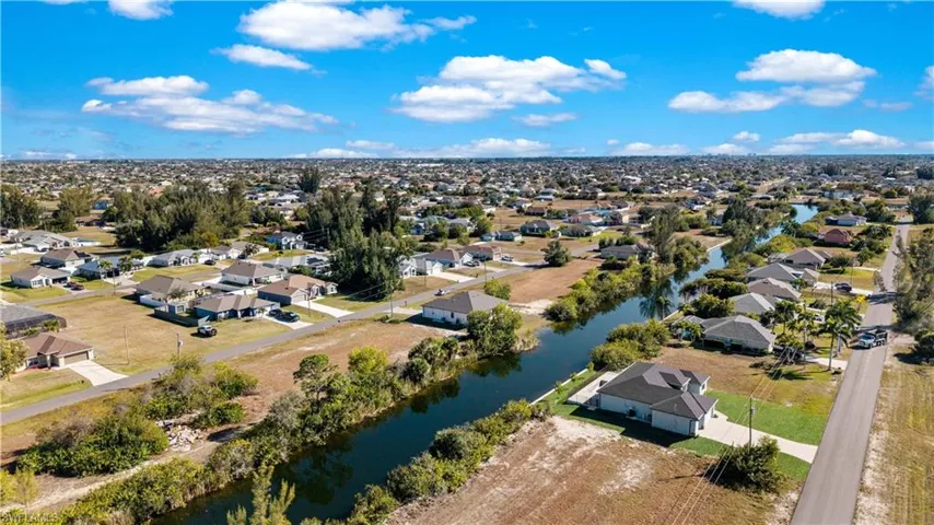 Aerial view of residential area featuring a nearby body of water