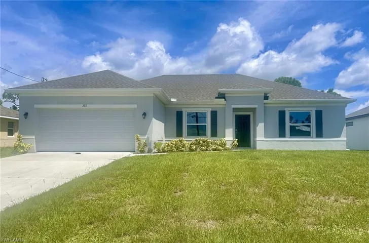 Ranch-style house featuring an attached garage, stucco siding, a front lawn, concrete driveway, and roof with shingles