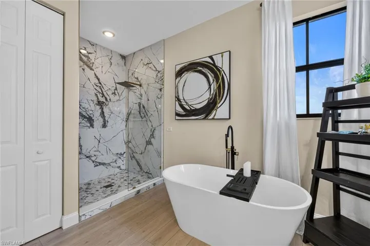 Freestanding soaking tub and walk in shower with upgraded tile