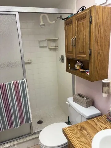 Full bathroom featuring a stall shower