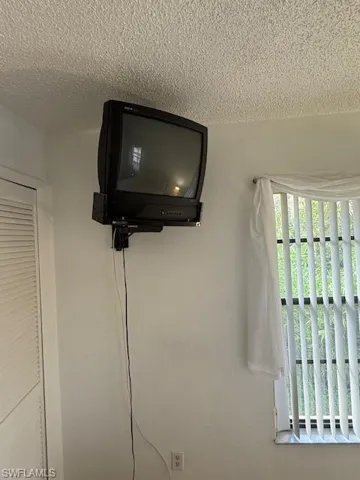 Tv in main bedroom with separate closets.