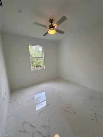 Empty room featuring ceiling fan