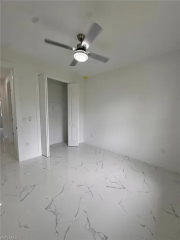 Empty room featuring ceiling fan